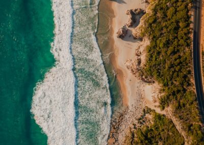 aerial view of green and brown land near body of water during daytime