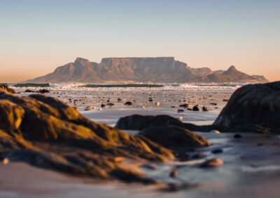 black rock formation on body of water during daytime